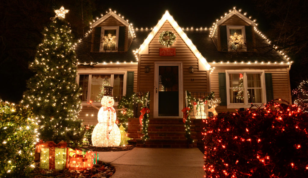 A small Cape Cod style house outlined with White Christmas Lights and Lawn Ornaments in Medford, NJ on December 24, 2014.